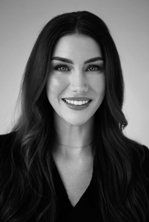 Woman posing with her hands on her face excentuating her dermal fillers and injections.